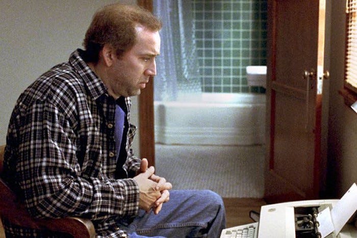 Image of Nicolas Cage as Charlie Kaufman sitting at a typewriter from Adaptation.