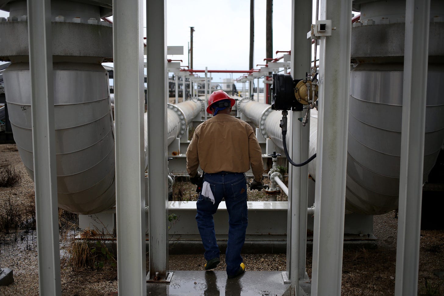 A person works on oil pipelines at the U.S. Department of Energy's Bryan Mound Strategic Petroleum Reserve in Freeport, Texas.