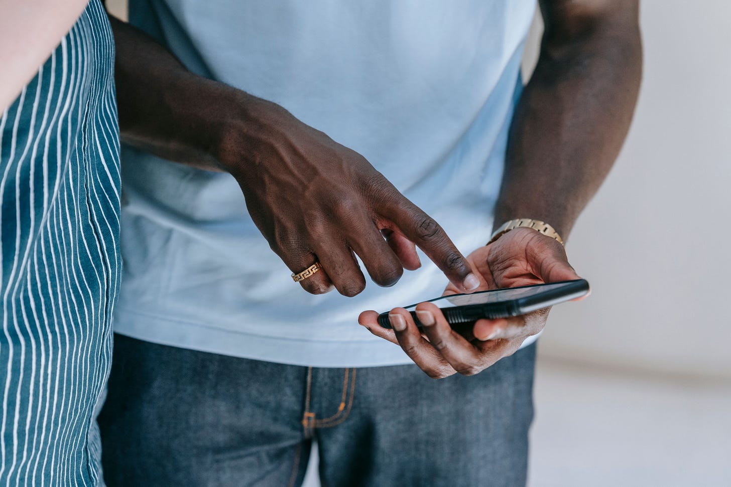 Close-up of a person interacting with a smartphone, captured indoors in a casual setting Close-up of a person interacting with a smartphone, captured indoors in a casual setting
