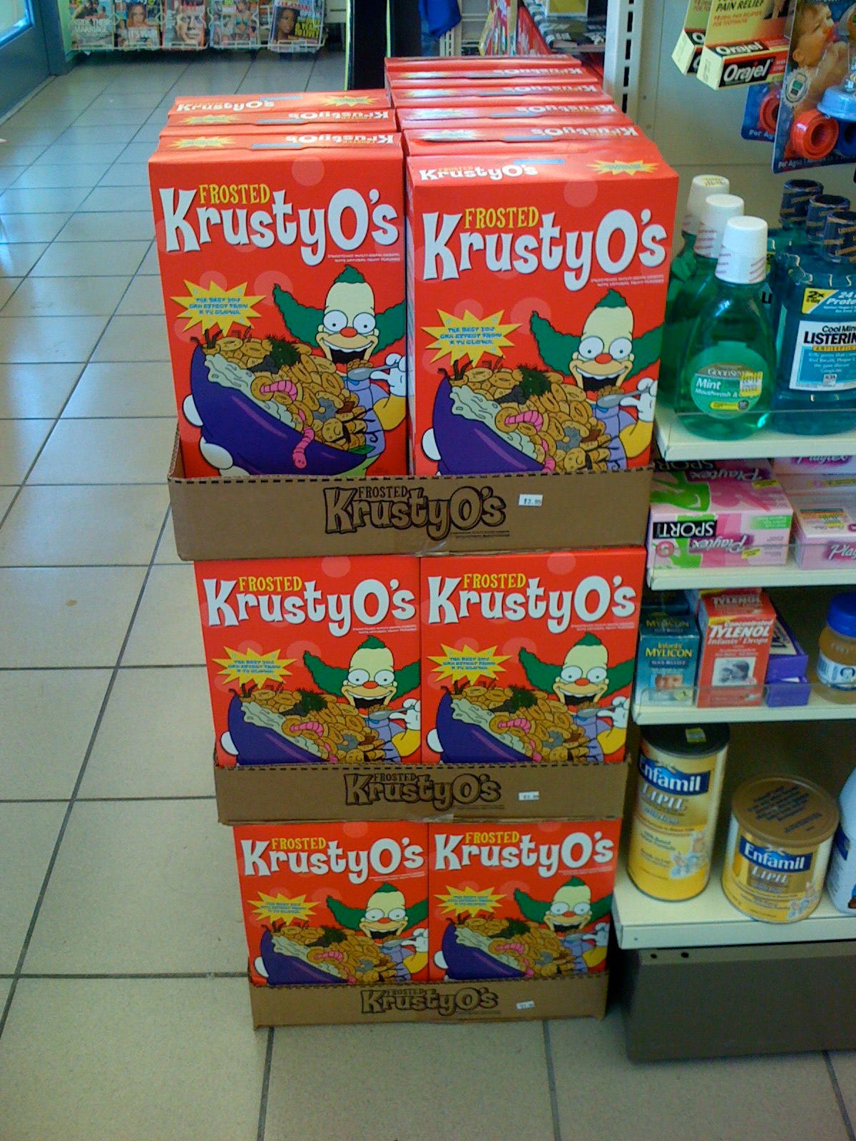 Boxes of Krusty-O's for sale are stacked up in a floor display. Looks like about 25 to 30 boxes on display.