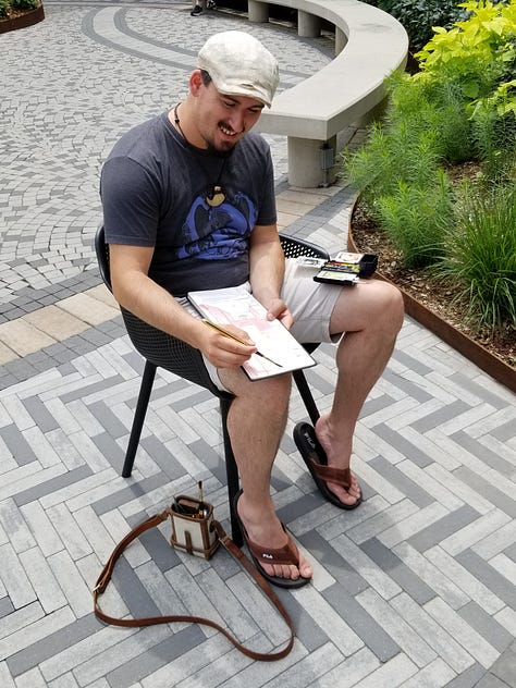 People sketching in an urban courtyard surrounded by flowers and other plants in beds.