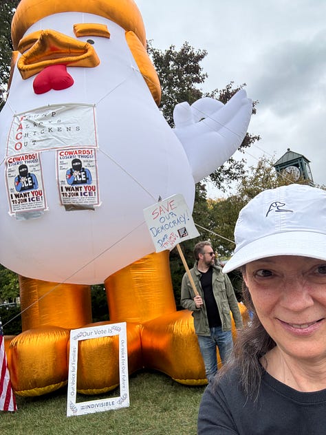Various protesters and dogs with signs at a NO KINGS rally