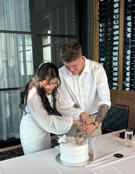 This photo provided by Jen Rickling shows U.S. Army staff sergeant, Matthew Blank, right, and his wife, Annie Ramos, cutting a cake while celebrating their wedding, in March 2026, in Houston. (Jen Rickling via AP) This photo provided by Jen Rickling shows U.S. Army staff sergeant, Matthew Blank, right, and his wife, Annie Ramos, cutting a cake while celebrating their wedding, in March 2026, in Houston. (Jen Rickling via AP)