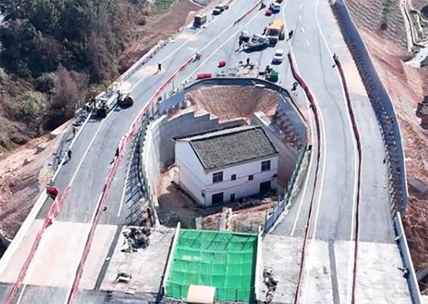 A 'nail house' in China, where a motorway has been built on either side of the house of someone who refused to sell up.
