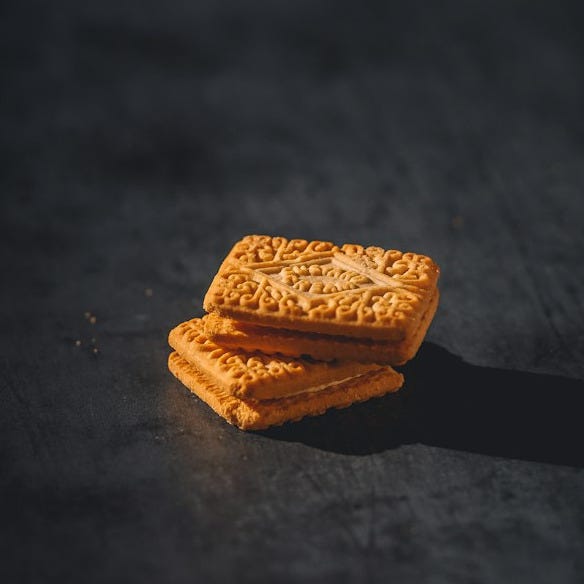a stack of crackers sitting on top of a black surface a stack of crackers sitting on top of a black surface