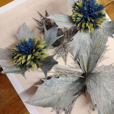 Image one Pink Roses, Image two bright red yellow and cream flowers on a small wreath with grasses, Image three paper sea holly photographed against an illustration of sea holly
