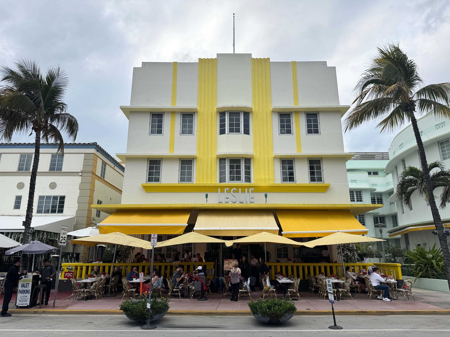 A 3-story white-and-yellow Art Deco building in Miami with lettering on the facade that says LESLIE