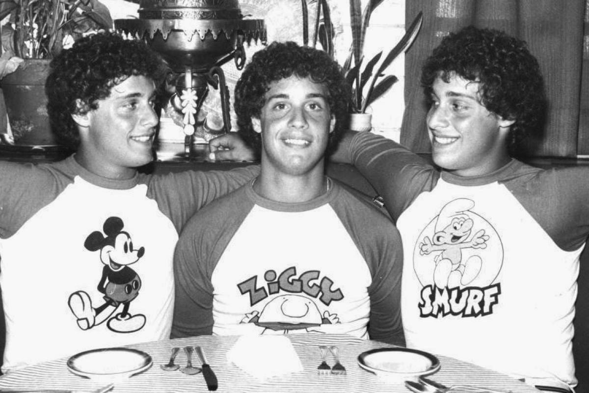 three identical strangers with mickey mouse shirts three identical strangers with mickey mouse shirts