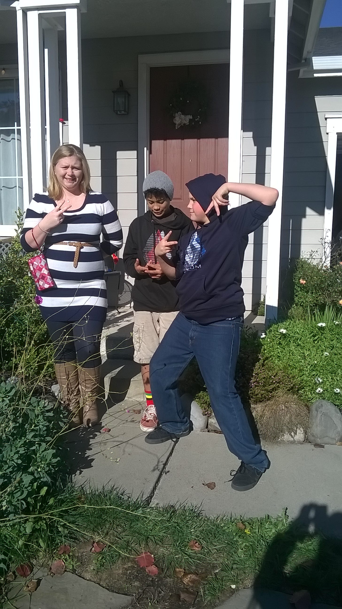 3 kids in front of house