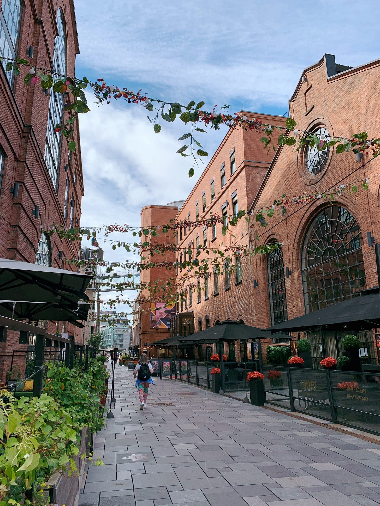 Pedestrian only-street surrounded by old industrial brick buildings