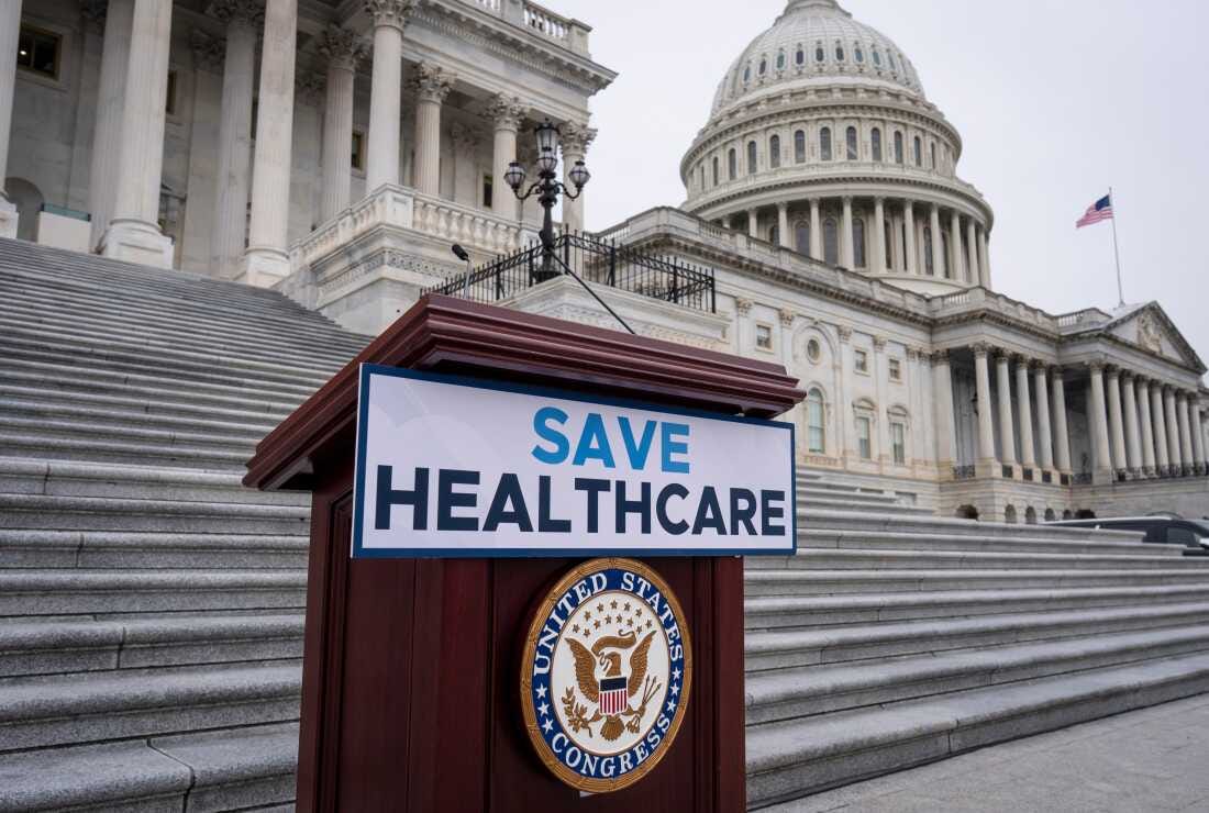 House Democrats prepare to speak on the steps of the Capitol to insist that Republicans include an extension of expiring health care benefits as part of a government funding compromise, in Washington, Tuesday, Sept. 30.