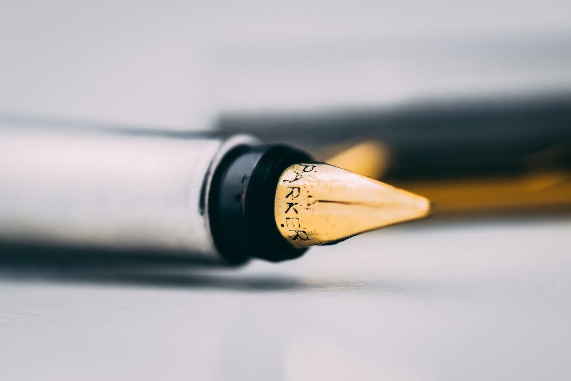 Free Selective Focus Photography of Fountain Pen on White Surface Stock Photo Free Selective Focus Photography of Fountain Pen on White Surface Stock Photo