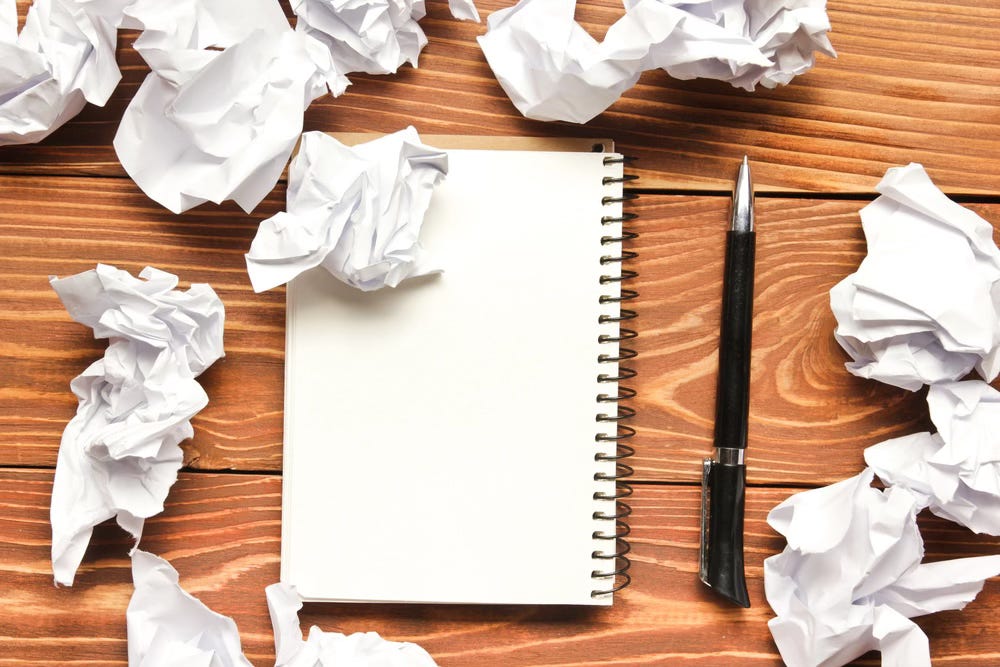 Notebook and wads of crumpled paper