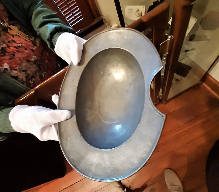 A bloodletting instrument is a small utensil with three blades, and a bloodletting bowl that is gray with one side notched.