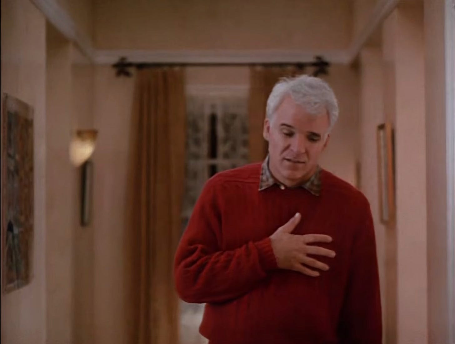 Steve Martin clutches his chest as George Banks.