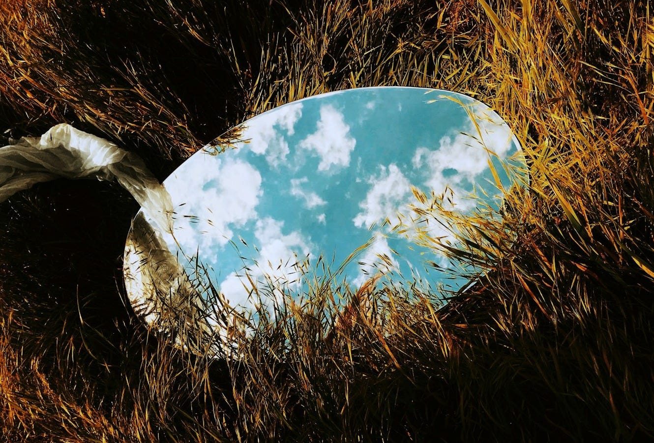 round mirror on grass
