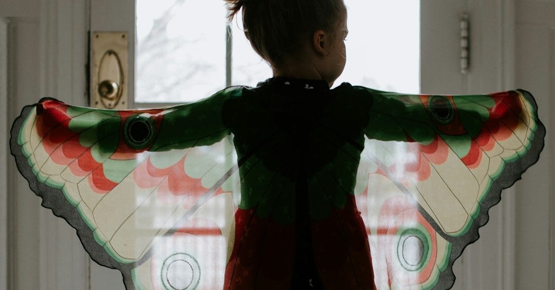 girl in black and red plaid jacket standing on white floor tiles