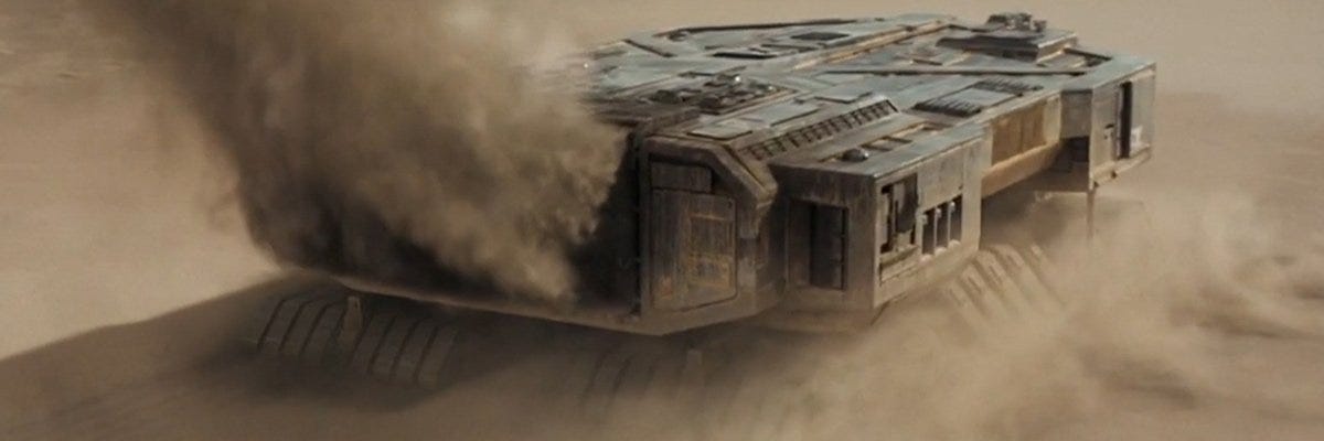 An Atreides spice harvester on planet Arrakis, with a plume of dust thrown up behind it