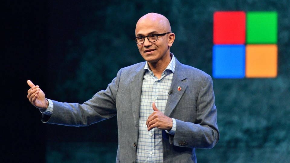 Microsoft CEO Satya Nadella speaking on a stage Microsoft CEO Satya Nadella speaking on a stage