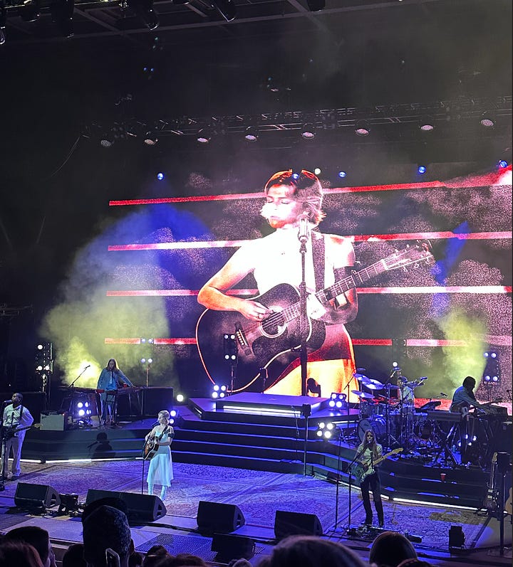 ashley wearing sunglasses looking at a cloud-filled sky, maggie rogers concert screen that say "I always find my way back to my feet," maggie rogers playing guitar
