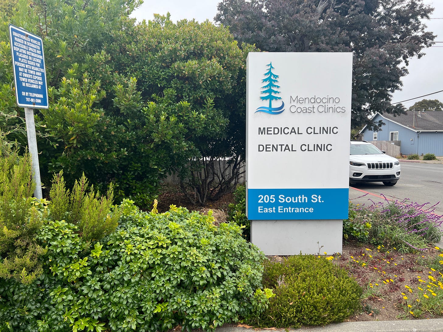 The Mendocino Coast Clinics sign in a garden The Mendocino Coast Clinics sign in a garden