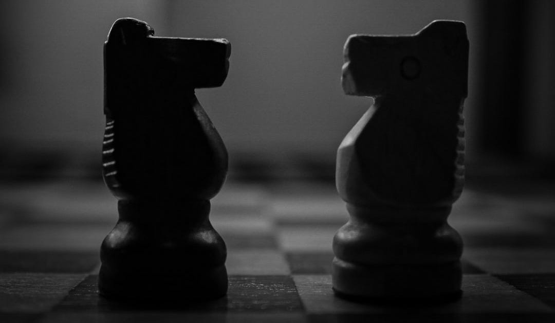 a black and white photo of two chess pieces a black and white photo of two chess pieces