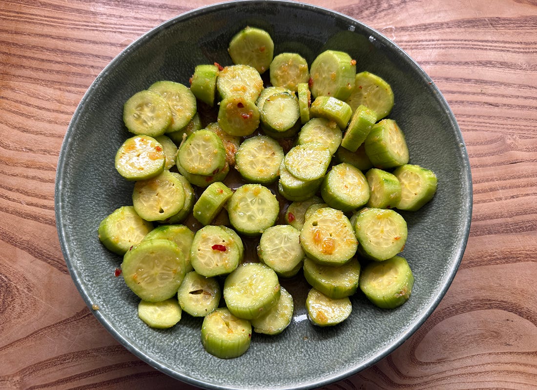 Tangy Asian Cucumber Salad on wooden table Tangy Asian Cucumber Salad on wooden table