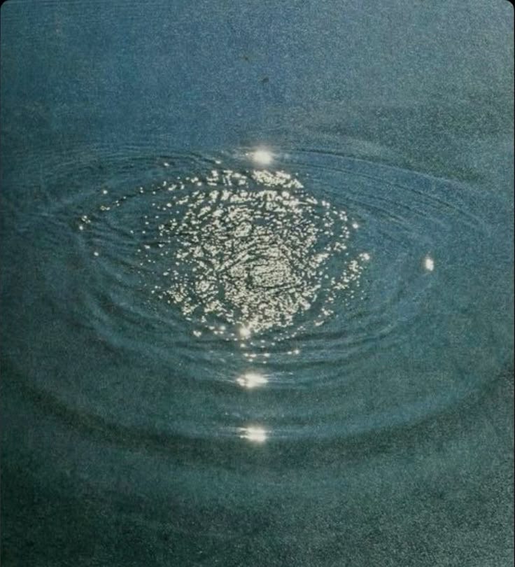 This may contain: water ripples in the middle of a body of water