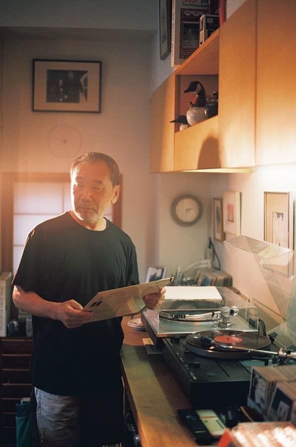 This may contain: a man standing next to a kitchen counter holding a piece of paper in his hand This may contain: a man standing next to a kitchen counter holding a piece of paper in his hand