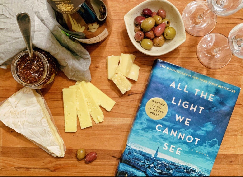 Photograph of French and German wine and cheese to immerse in the text of All The Light We Cannot See.