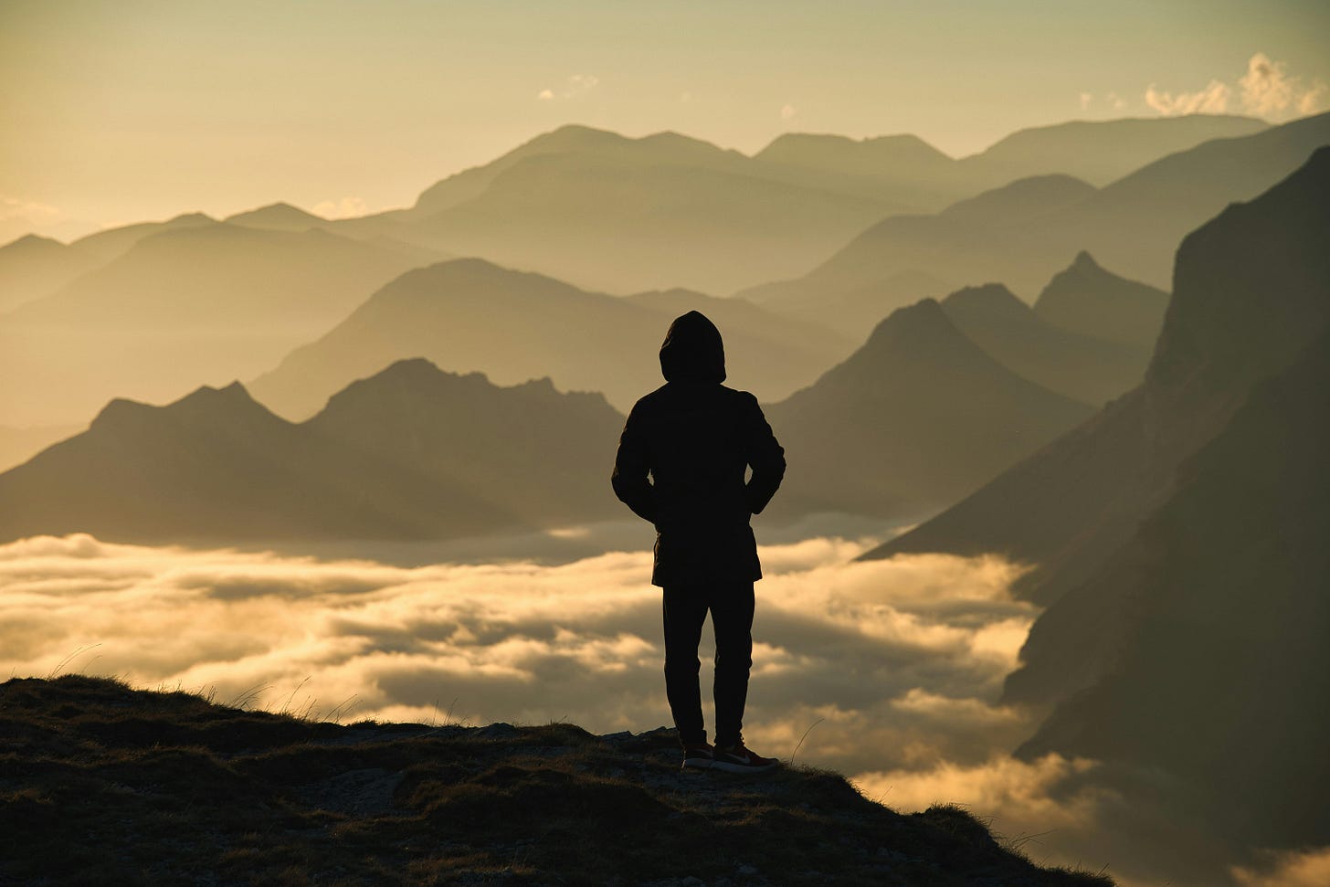 Silhouette of Man Standing on Top of Mountain · Free Stock Photo