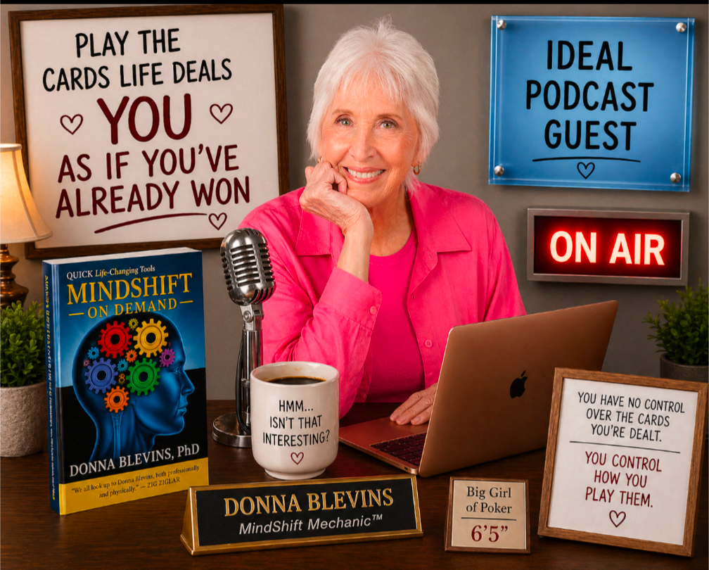 Donna Blevins sits smiling at a desk in a bright pink blouse with a microphone, laptop, coffee mug, and her book MindShift On-Demand. Signs around her feature poker-inspired mindset messages, an “On Air” light, and “Ideal Podcast Guest.”