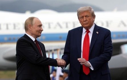 US President Donald Trump (R) and Russian president Vladimir Putin pose on the podium at the airbase in Alaska.