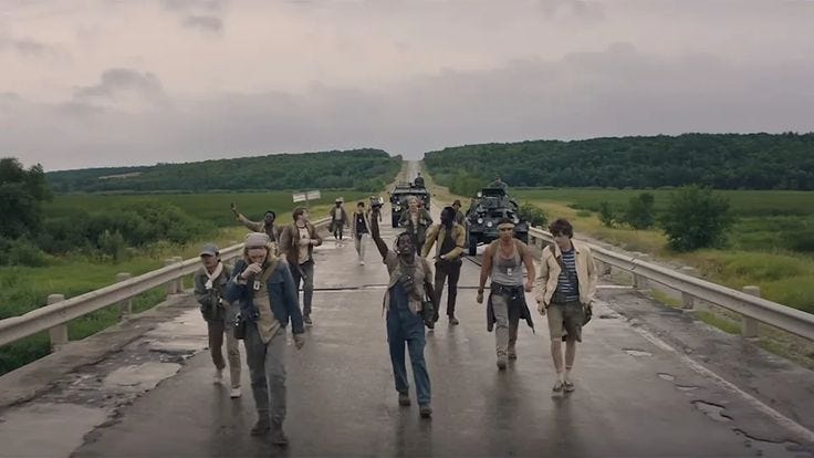 This may contain: a group of people walking across a bridge