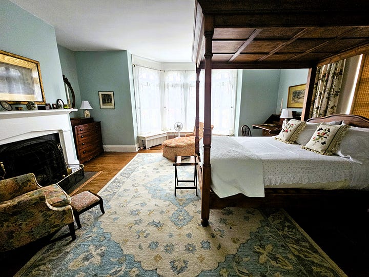 Bedroom shots, showing high four poster beds with Oriental rugs on the floor.