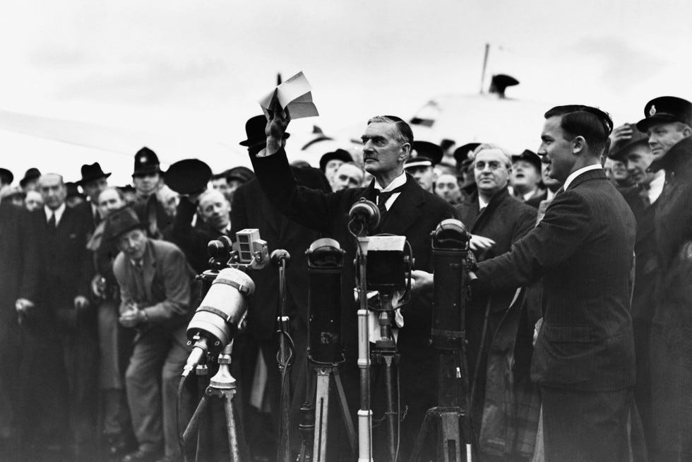 Neville Chamberlain shows off the Anglo-German Declaration at Heston Aerodrome