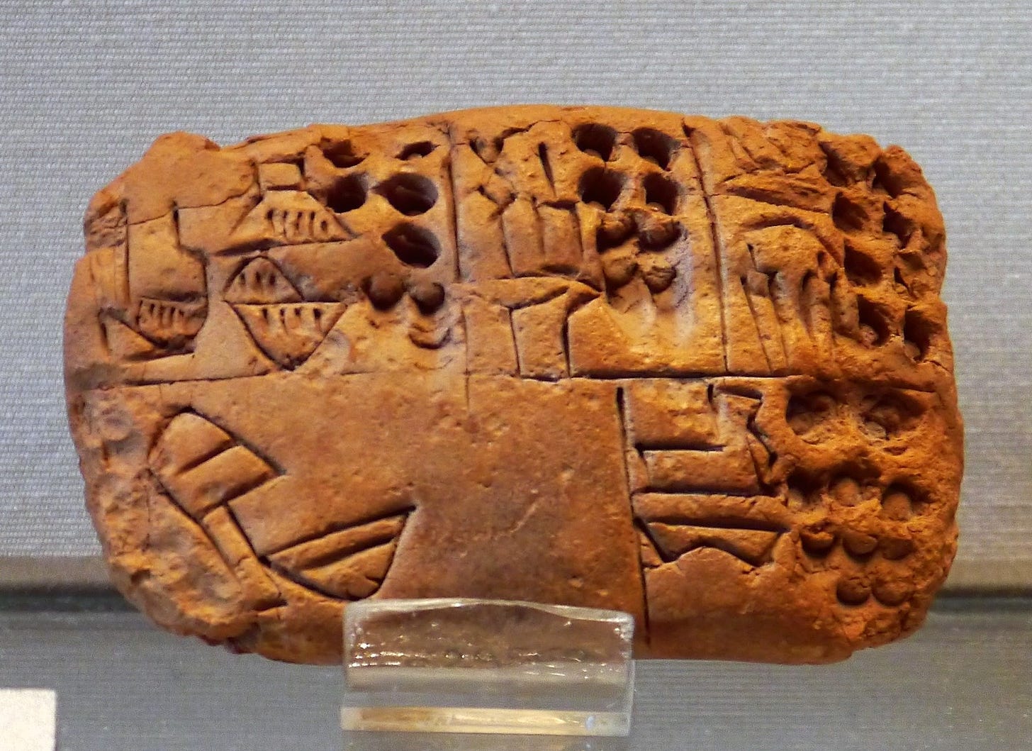 Small administrative tablet, Uruk III phase, recording the distribution of rations, with irregular arrangement of the cases. Louvre Museum. Small administrative tablet, Uruk III phase, recording the distribution of rations, with irregular arrangement of the cases. Louvre Museum.