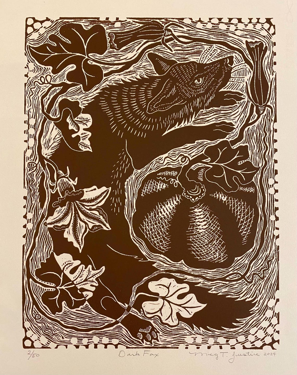 May include: Brown and beige linocut print titled 'Dark Fox' by Meg T. Justice, 2024. The print features a stylized fox among leaves and a pumpkin. Numbered 4/50 in the bottom left corner.