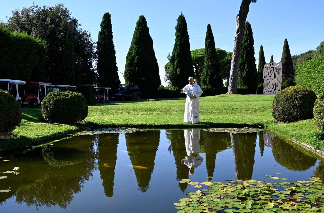 Pope Leo XIV walks beside a lily pond in the gardens of Borgo Laudato Si’ at Castel Gandolfo