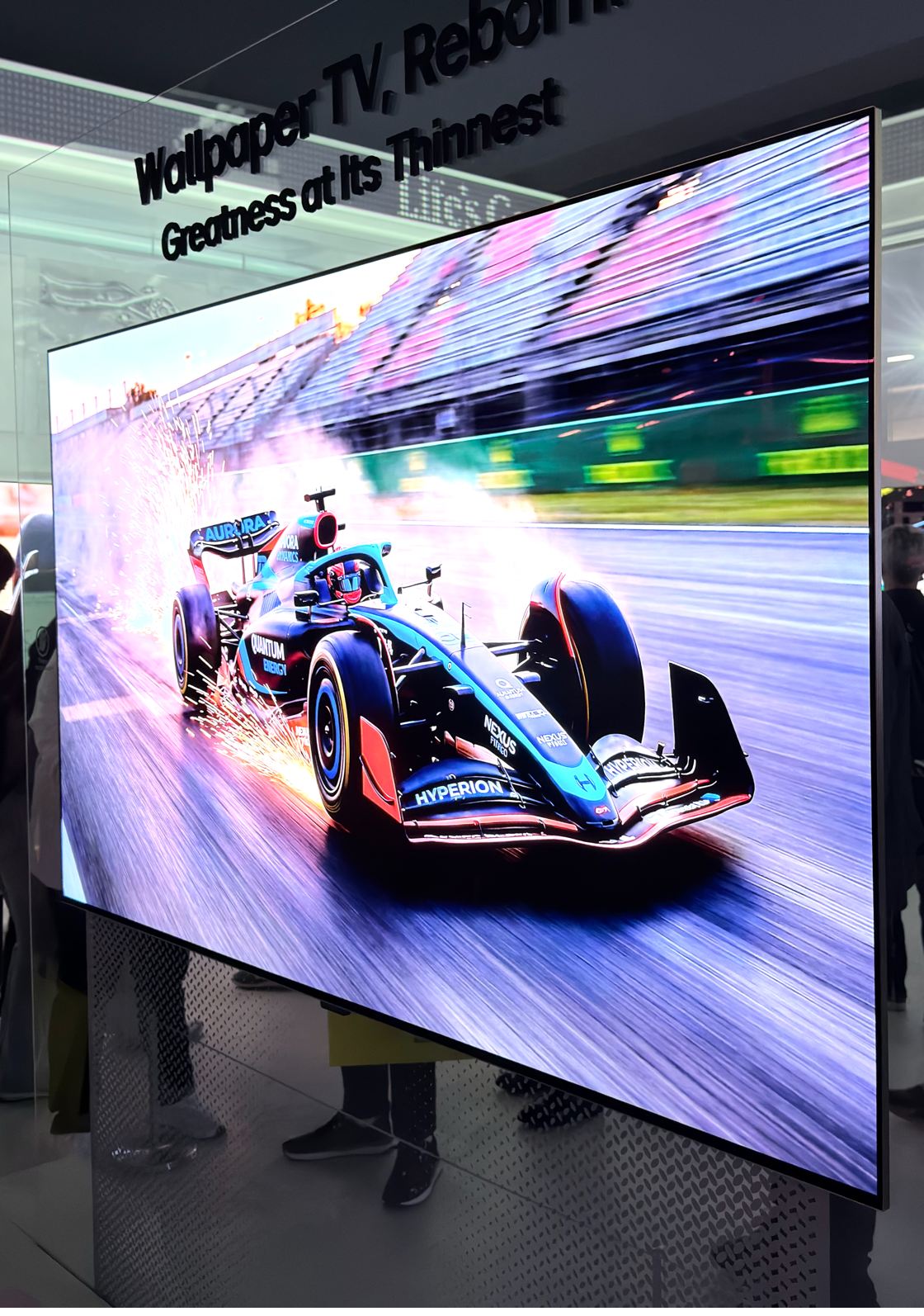 A large tv with a race car on it

AI-generated content may be incorrect.
