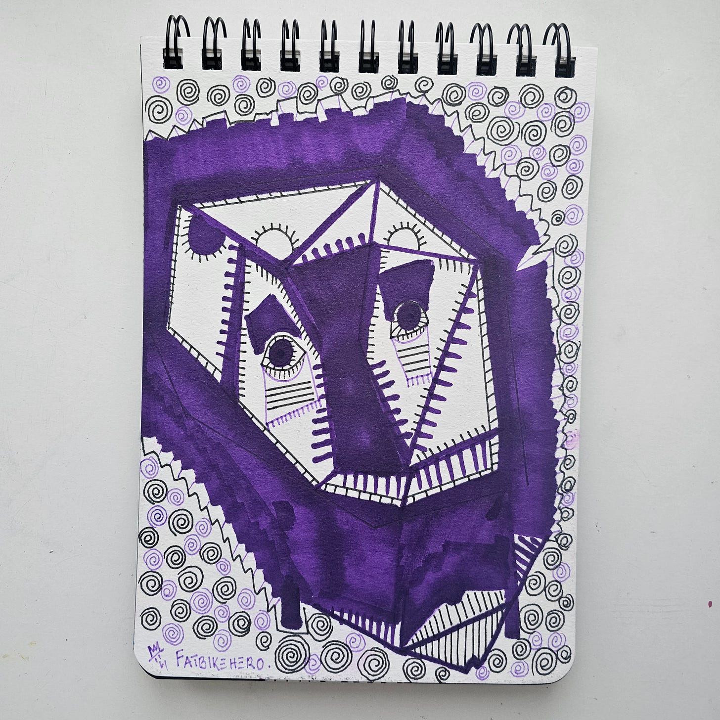    "A geometric abstract drawing titled 'Lion Purple' by artist FatbikeHero (b. 1983). The artwork features a stylized, purple marker interpretation of a lion's face inside a cubist box structure, surrounded by black ink spirals on a sketchbook page."