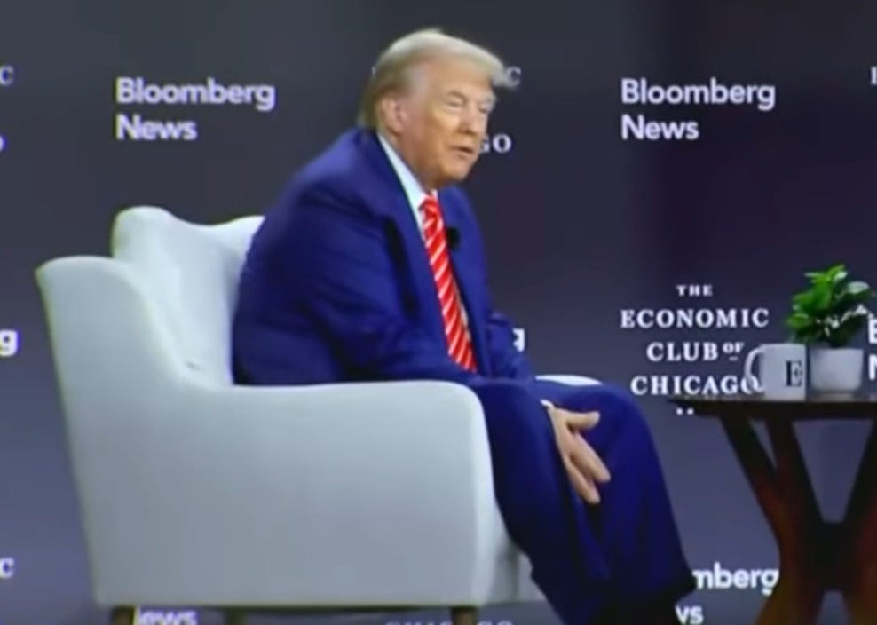 Donald Trump sits in a chair, his hands clasped oddly below his knees. Donald Trump sits in a chair, his hands clasped oddly below his knees.