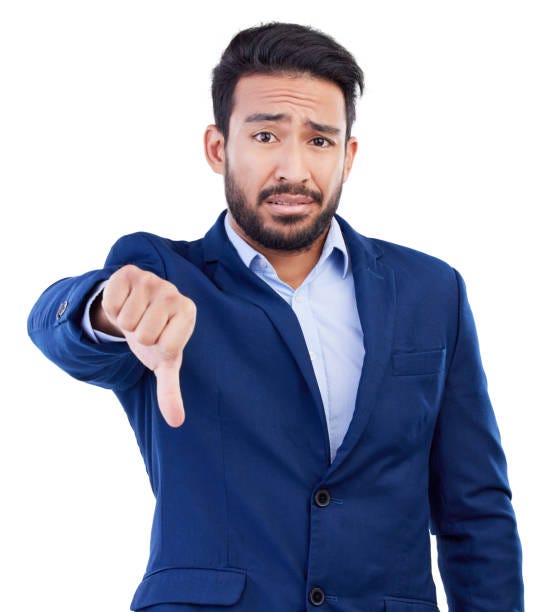 man with thumb down and disappointed look