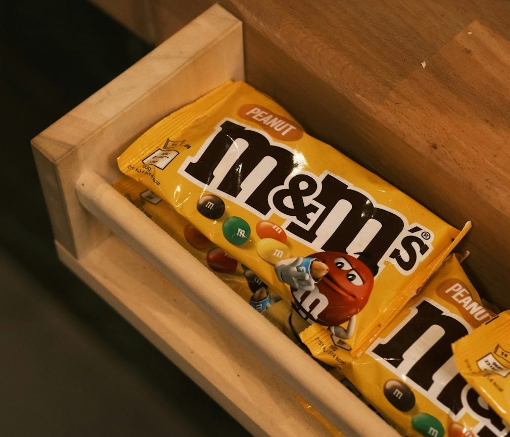 A box of m & m's is sitting on a table