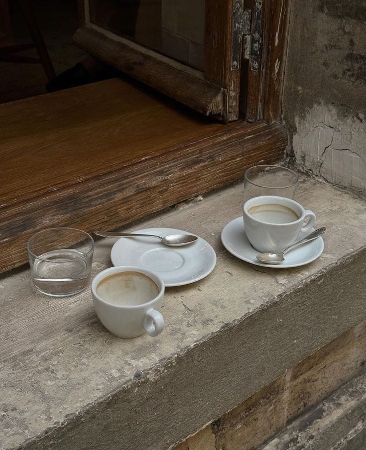 This may contain: two cups and saucers sitting on a window sill