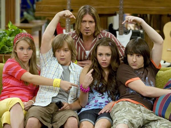 This may contain: a group of kids sitting on top of a couch in front of a tv screen This may contain: a group of kids sitting on top of a couch in front of a tv screen