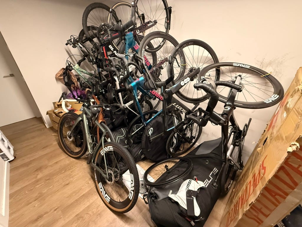 a tangled mess of bikes hanging on a wall