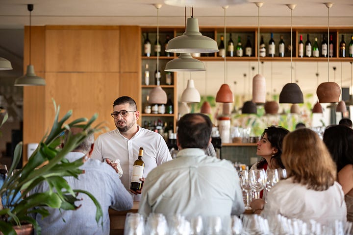 photos provided by Quinta do Quetzal winery, sommeliers pouring wine to guests