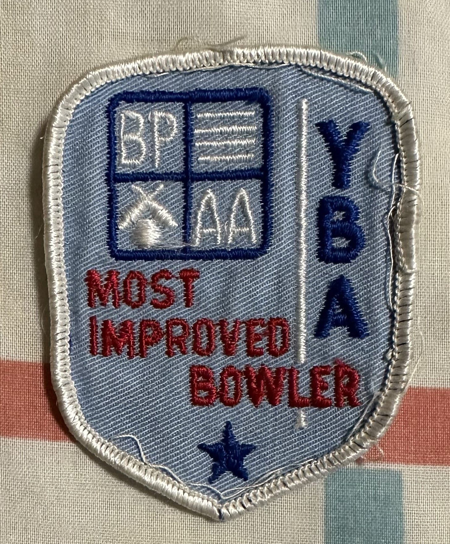 Cloth patch reading "Most Improved Bowler" and "YBA" (Youth Bowling Association) with BPAA insignia.
