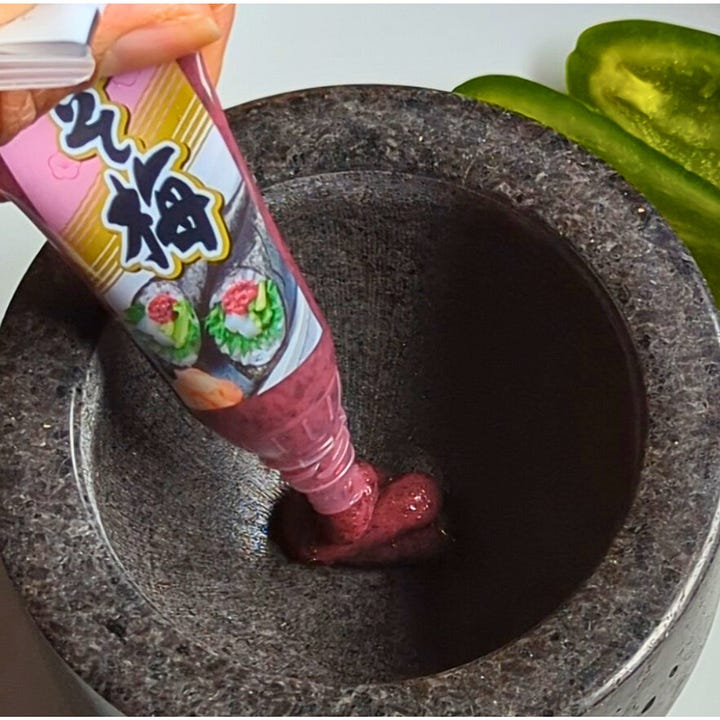 Marisa preparing umeboshi paste in a mortar and pestle, followed by a plated tomato “tuna” sashimi topped with pickled plum and jalapeño chutney.